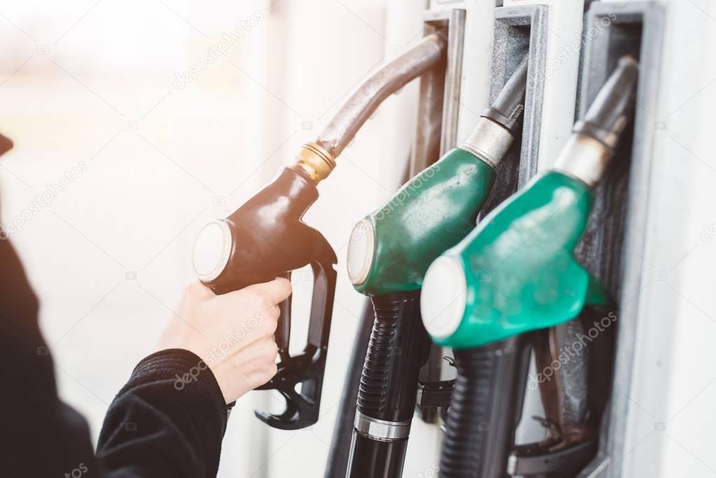 Woman holding diesel fuel nozzle