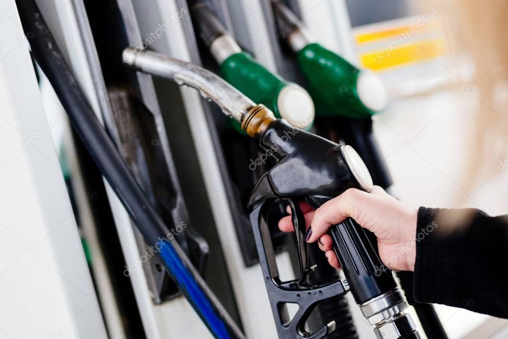 Woman holding diesel fuel nozzle