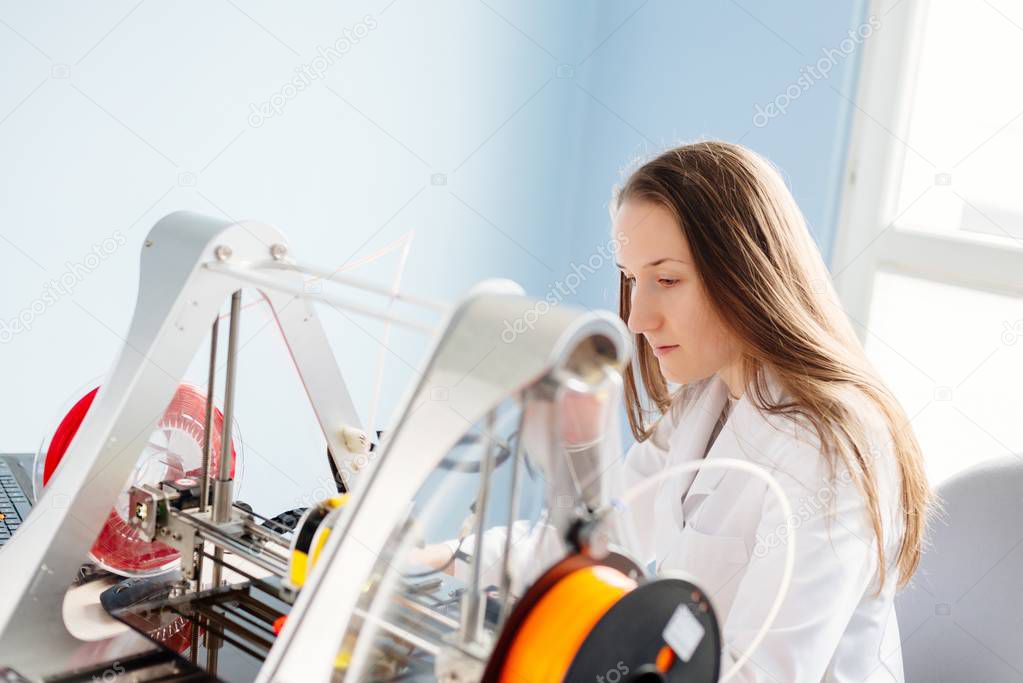 Woman working with 3d printer