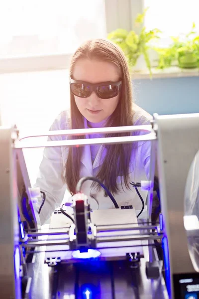 Woman working with laser engraver