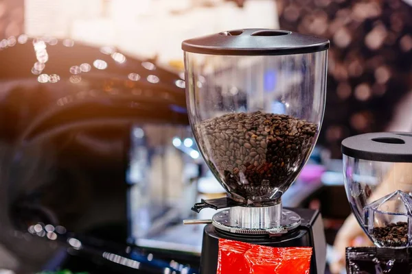 Beans of brown coffee in coffee grinder. — Stock Photo, Image