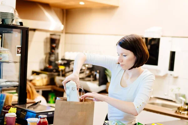 Woman small local shop owner packing shopping — Stock Photo, Image