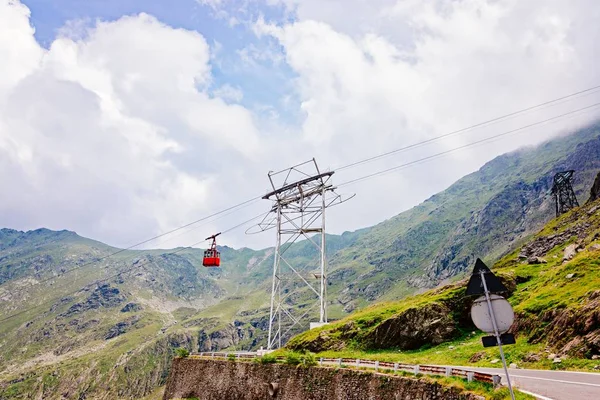 Carro de cabo vermelho sobre a estrada da montanha Transfagarasan — Fotografia de Stock