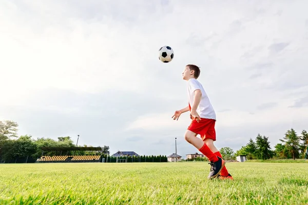 8 років хлопчик дитина грає у футбол — стокове фото