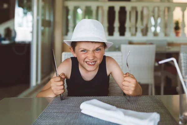 Hungry boy waiting for dinner in restaurant. — Stock Photo, Image