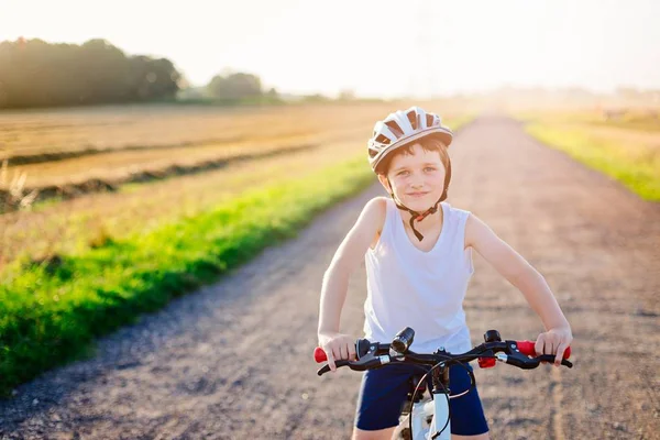 Happy boy in a bicycle helmet on his bike. — Stock Photo, Image