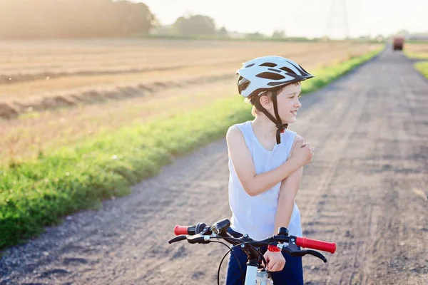 Happy boy in a bicycle helmet on his bike. — Stock Photo, Image