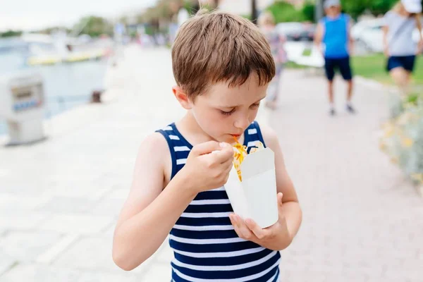 Child eating fast food noodles