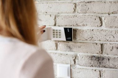 Ev alarm tuş takımında şifrenizi girerek kadın.