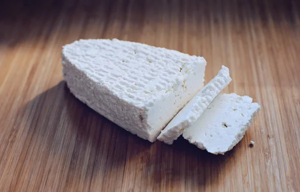 White healthy cottage cheese on wooden cutting board — Stock Photo, Image