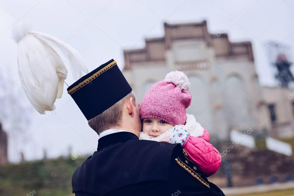 Black coal foreman miner in gala uniform with his child.