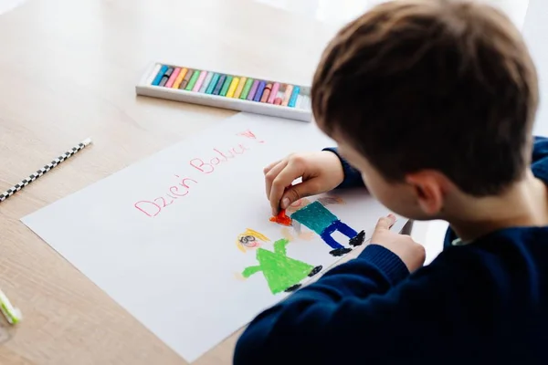 Glückliches polnisches Kind beim Zeichnen einer Grußkarte für seine Oma. — Stockfoto