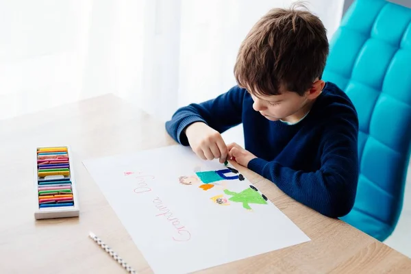 Glücklich 8 Jahre Junge Kind zeichnet eine Grußkarte für seine Oma — Stockfoto