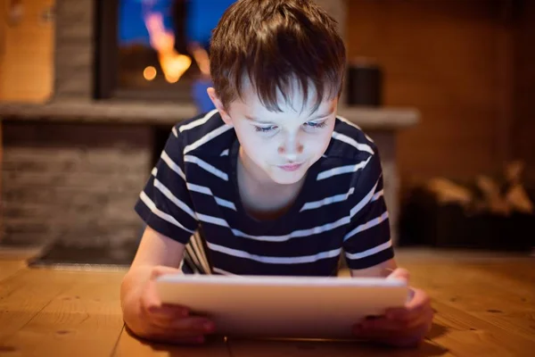 Eight years old boy using digital tablet — Stock Photo, Image