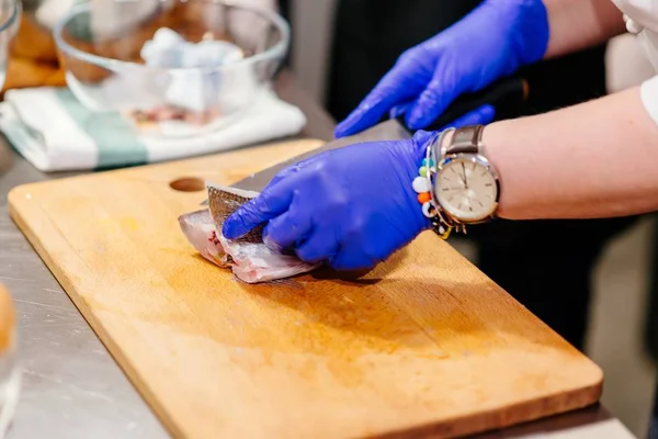 Hazırlama ve ham dorada Balık Temizleme kadın aşçı — Stok fotoğraf