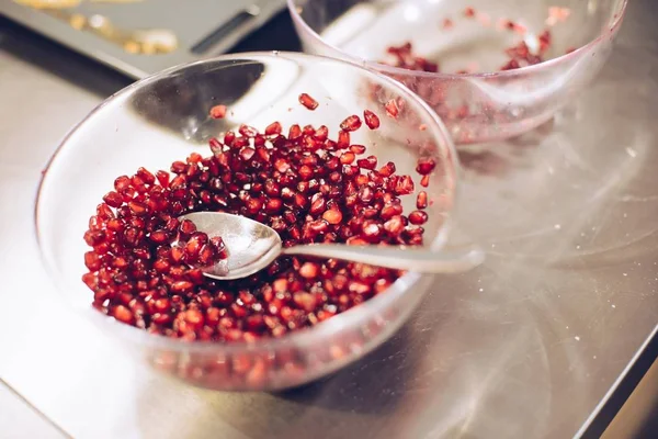 Red pomegranate seeds in glass bowl — Stock Photo, Image