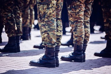 Soldiers in masking camouflage uniforms on parade clipart