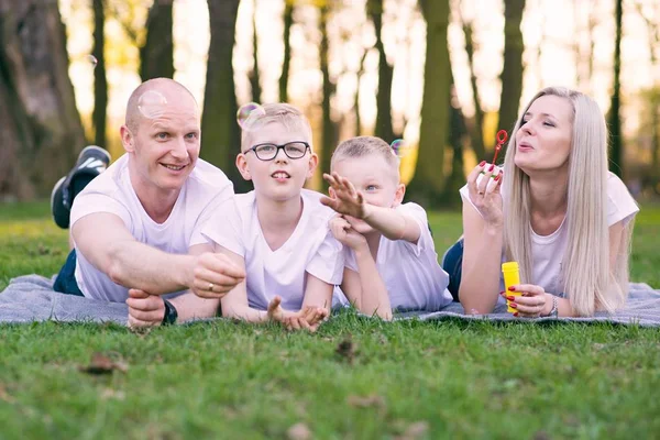 Family blowing soap bubbles