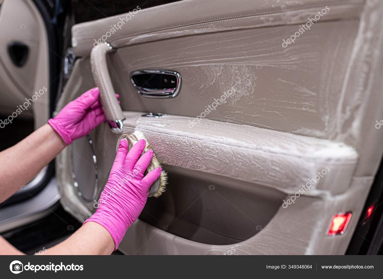 Cleaning car leather interior with brush. Car detailing Stock