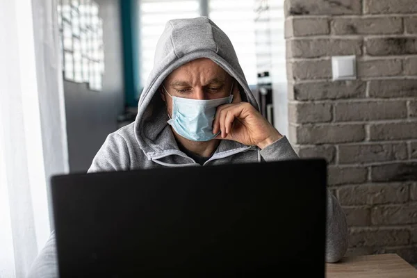 Man working at home in medical mask. Home office