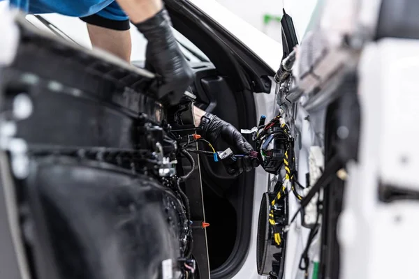 İnsan araba fabrikası ya da servis işçisi araba elektrikli ekipman monte eder — Stok fotoğraf