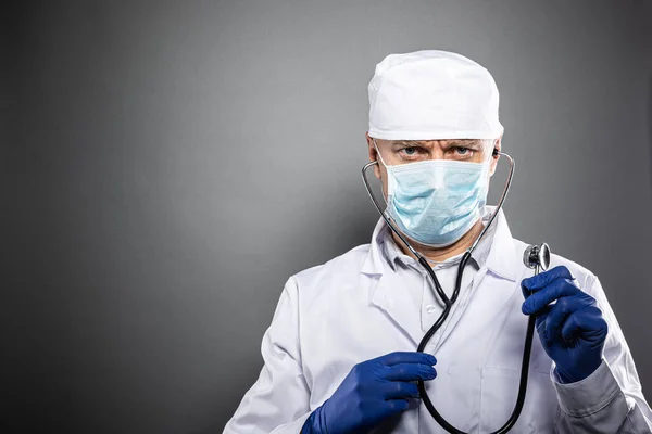 Studio shot of doctor in medical protective mask — Stock Photo, Image
