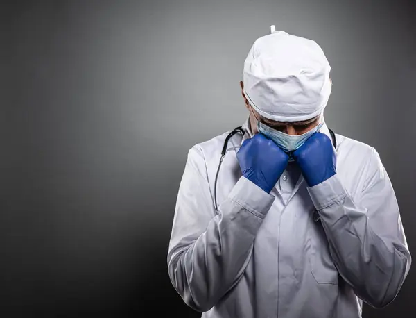 Overworked tired doctor in white uniform and medical mask. — Stock Photo, Image