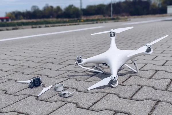 Crashed modern drone and camera after drone accident