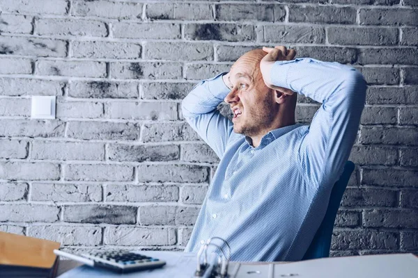 Worried confused man in shirt working in the office