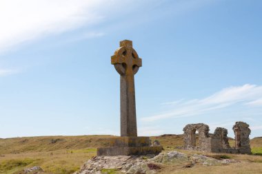 Celtic cross and remains of St Dynwen's church, Llandwyn, Angles clipart