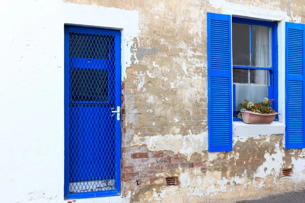 Old house with blue door and window shutters — Stock Photo, Image