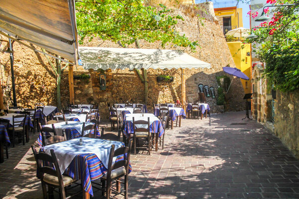 Chania, Crete - July 24th 2016: Courtyard of a restaurant.  Many tourists visit the town.
