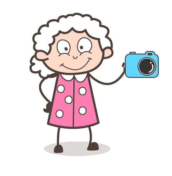 Cartone animato nonnina mostrando una macchina fotografica vettoriale illustrazione — Vettoriale Stock