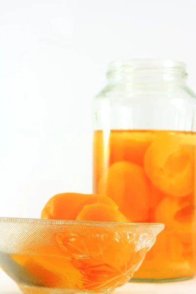 Apricots in a glass bottle — Stock Photo, Image
