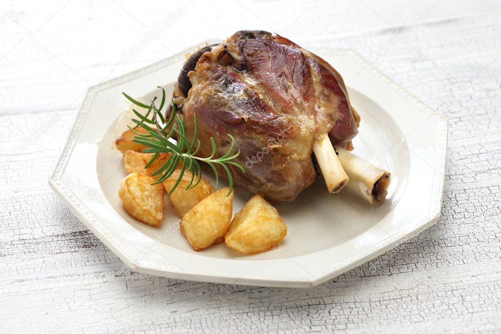 pork shank with roasted potatoes, italian cuisine