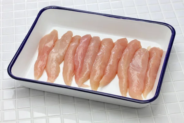 Raw chicken tenders on butcher tray — Stock Photo, Image