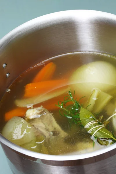 Hacer caldo de sopa de pollo (caldo) en una olla —  Fotos de Stock