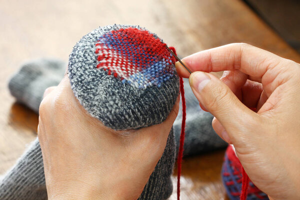 darning socks, repairing holes in socks