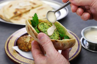 Mısır falafeli tahini soslu pide servis edilir.