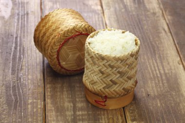 steamed sticky rice is in bamboo container ; thai laos food