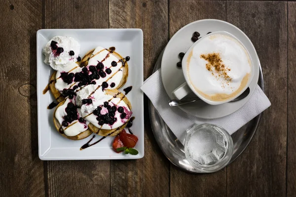 Kaffee-Cappuccino und fruchtige Pfannkuchen Stockbild