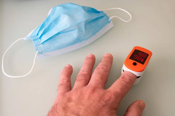 Pulse oximeter digital portable device for monitoring blood oxygen saturation and heart rate. Medical equipment for health examination. Coronavirus symptoms concept.
