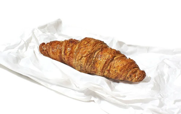 Croissant on a grocery paper bag. — Stock Photo, Image