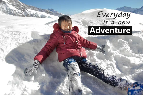 Everyday is a new adventure quote design word with Asian kid play on snow