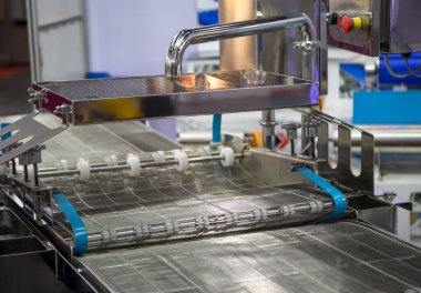 Empty wire belt conveyor in production line in food industry clipart