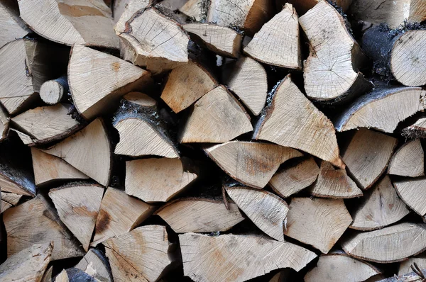 Pile of stacked triangle firewood prepared for fireplace and boi — Stock Photo, Image