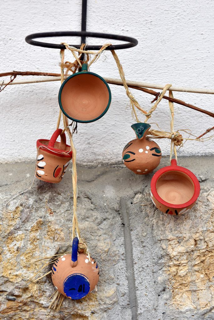 Hanging clay jugs and cups on the wall