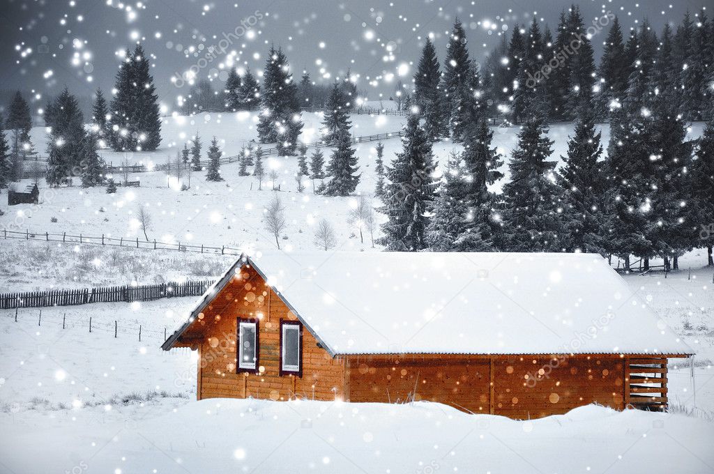 Mountain hut in winter with snowflakes. Christmas concept