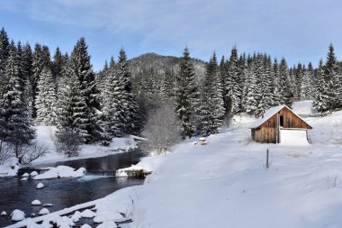 Dağlarda kar ile kaplı dağ evi