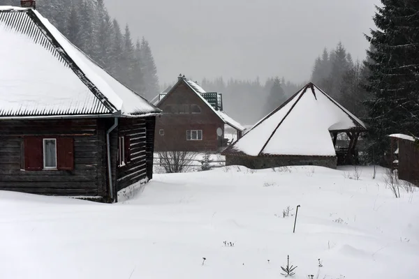Casa alpina coberta de neve nas montanhas — Fotografia de Stock